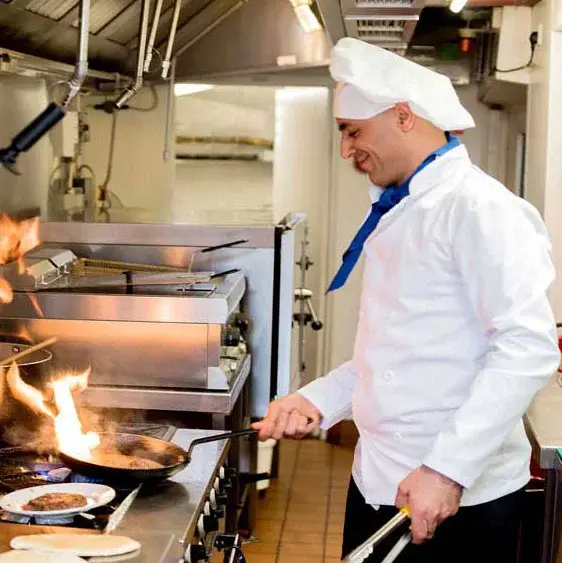 Hawthorn Senior Living Culinary Services, Chef frying at cook top