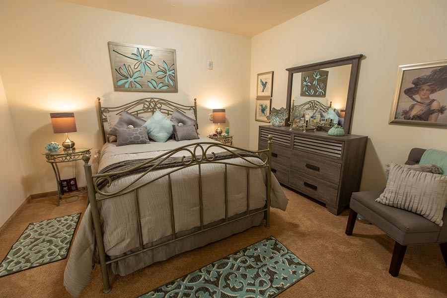 A furnished bedroom in a Summit Glen apartment